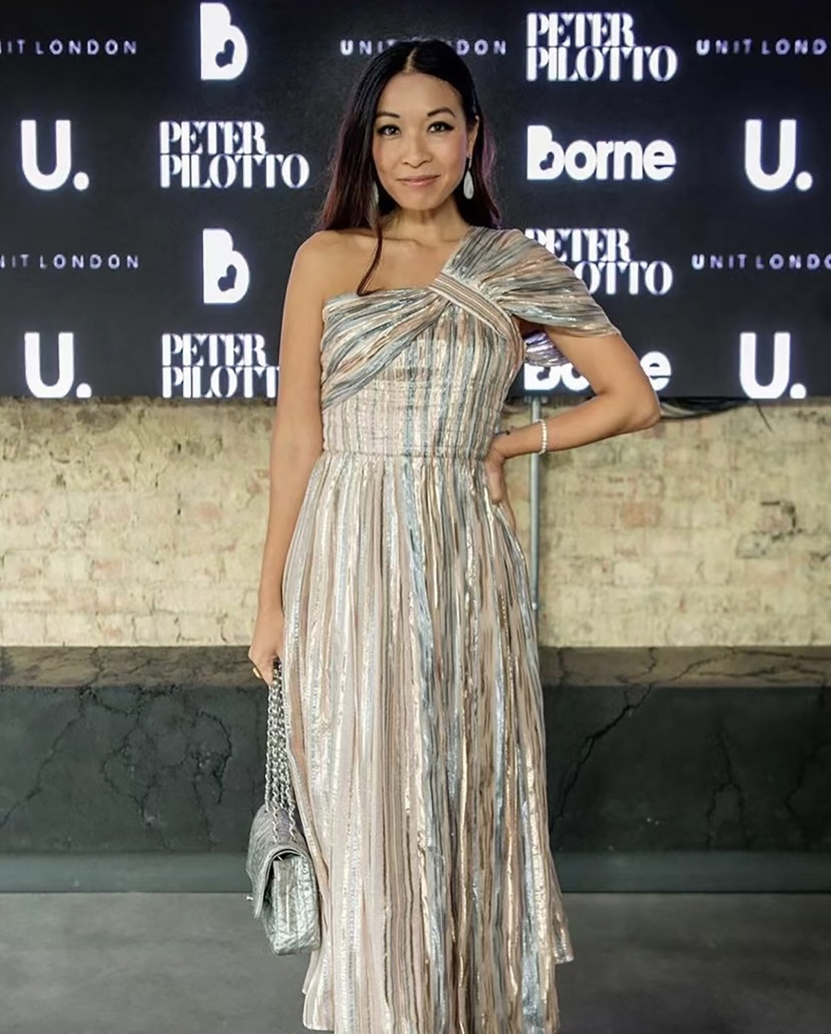 A woman in a silver one shoulder dress