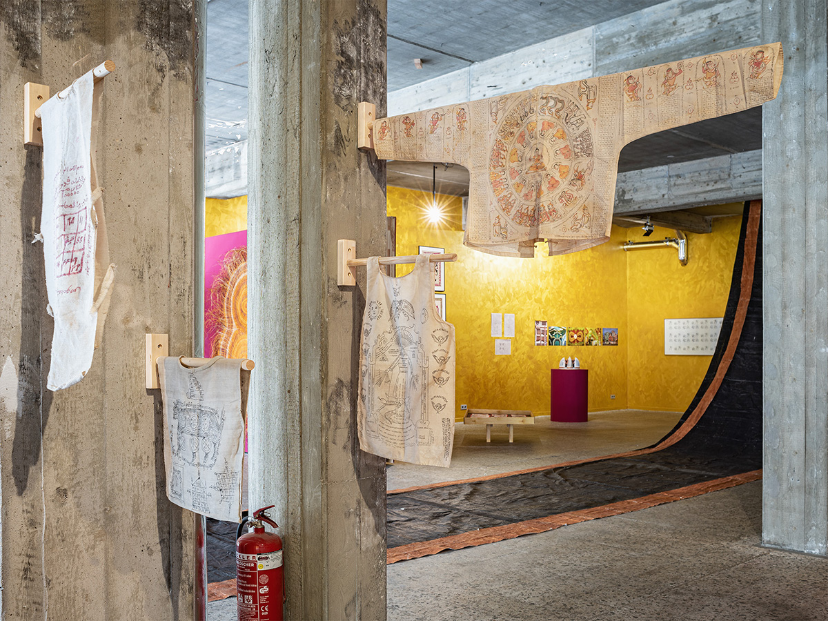 clothes hanging on wooden bars in a gold art gallery