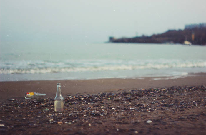 a bottle and rubbish on the beach