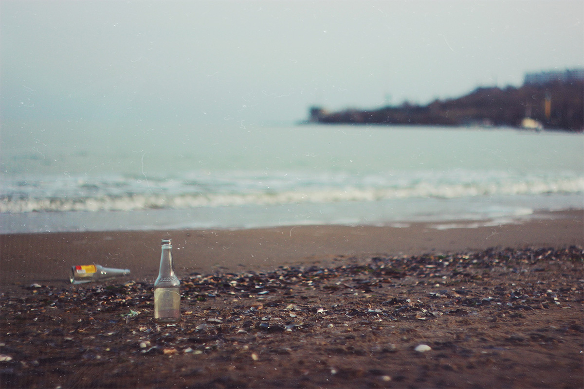 a bottle and rubbish on the beach