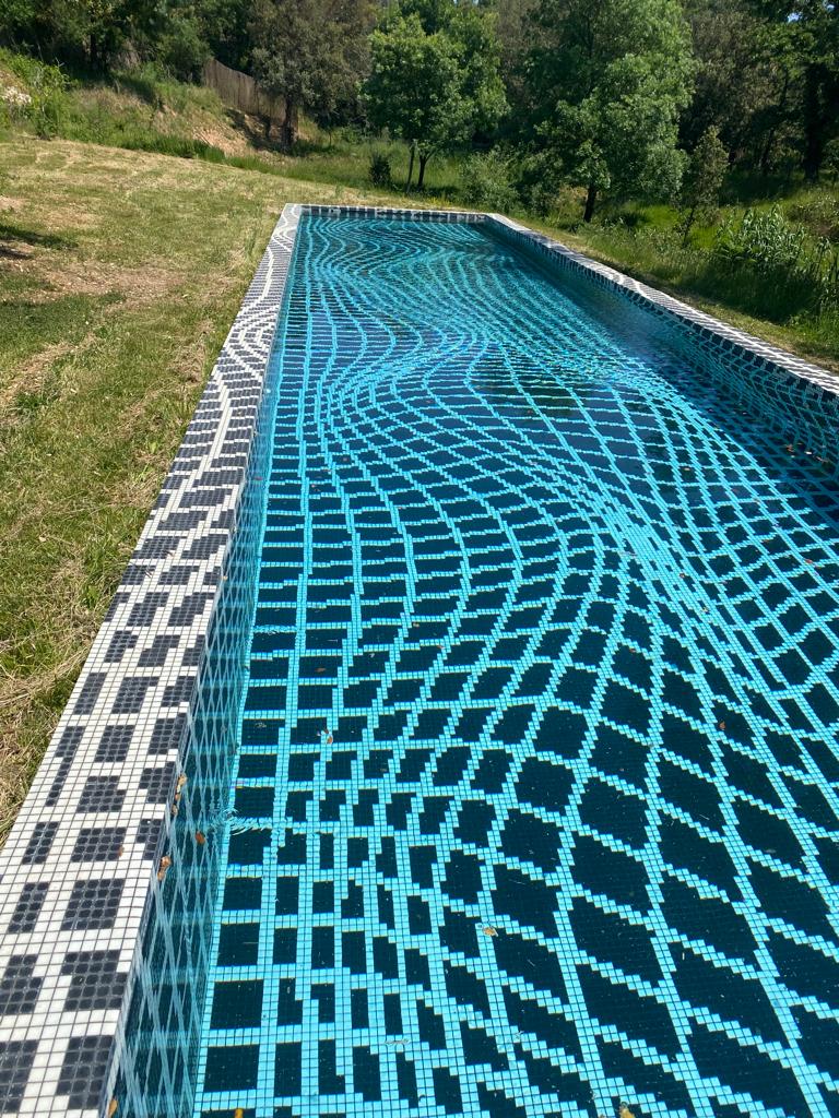 a swimming pool with black tiles