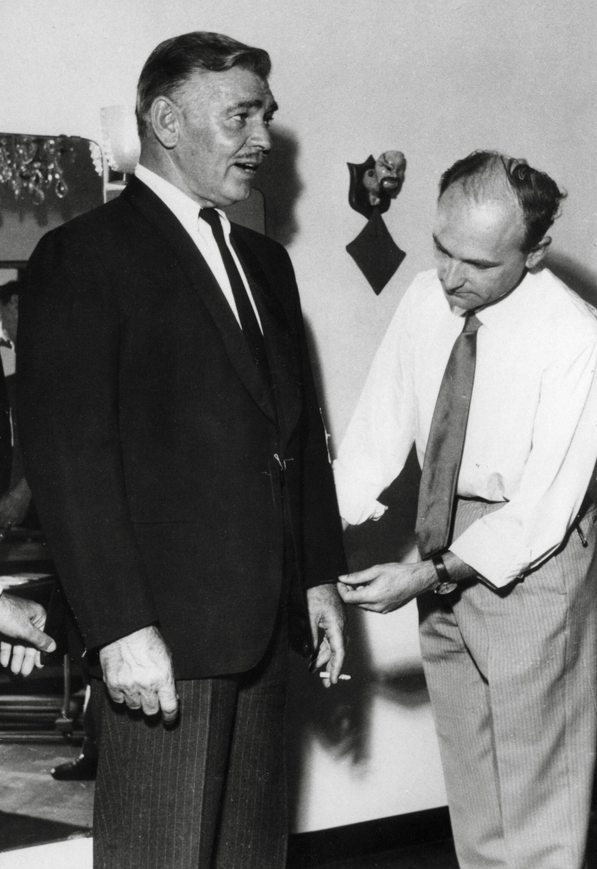 A man getting his suit fit by a tailor