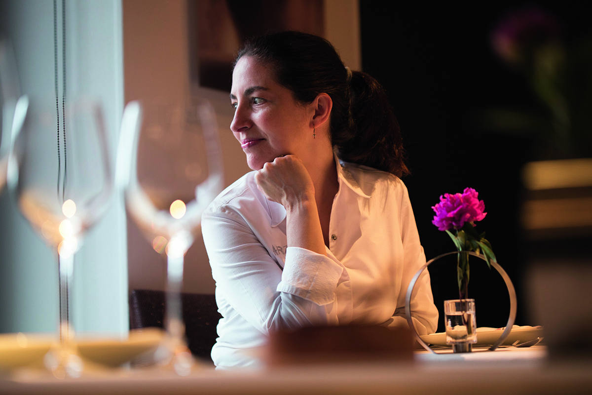 A woman with brown hair wearing a white shirt