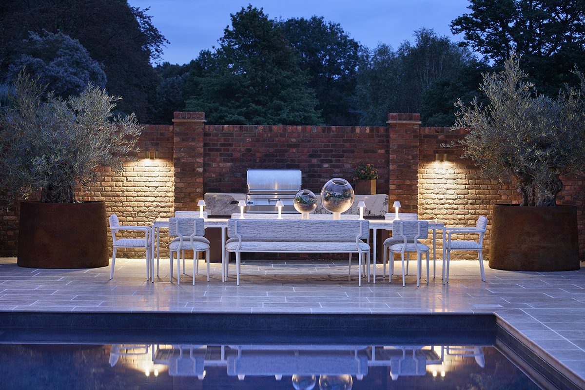 white tables and chairs in front of a swimming pool