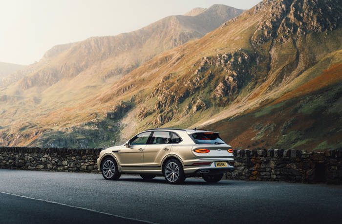 bentley car driving amid mountains