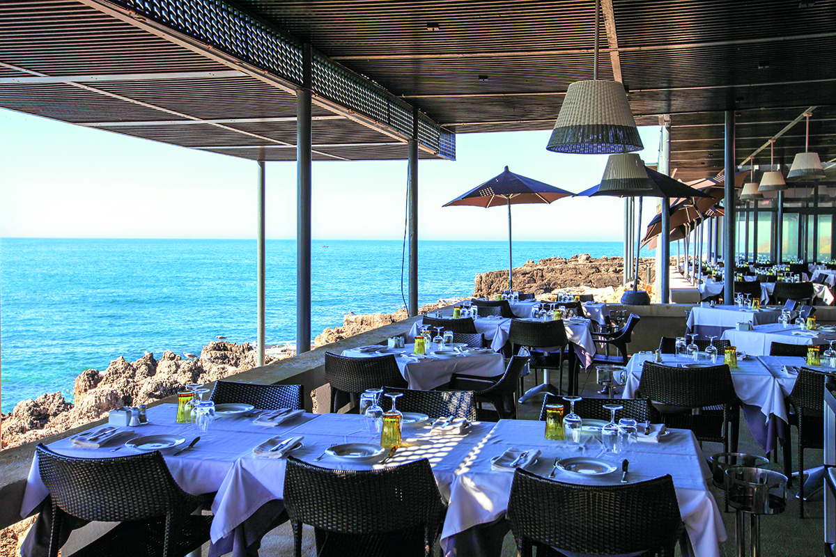 A restaurant by the sea with parasols