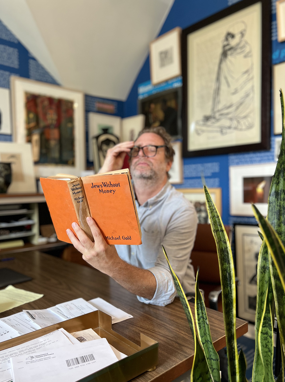 A man reading an orange book