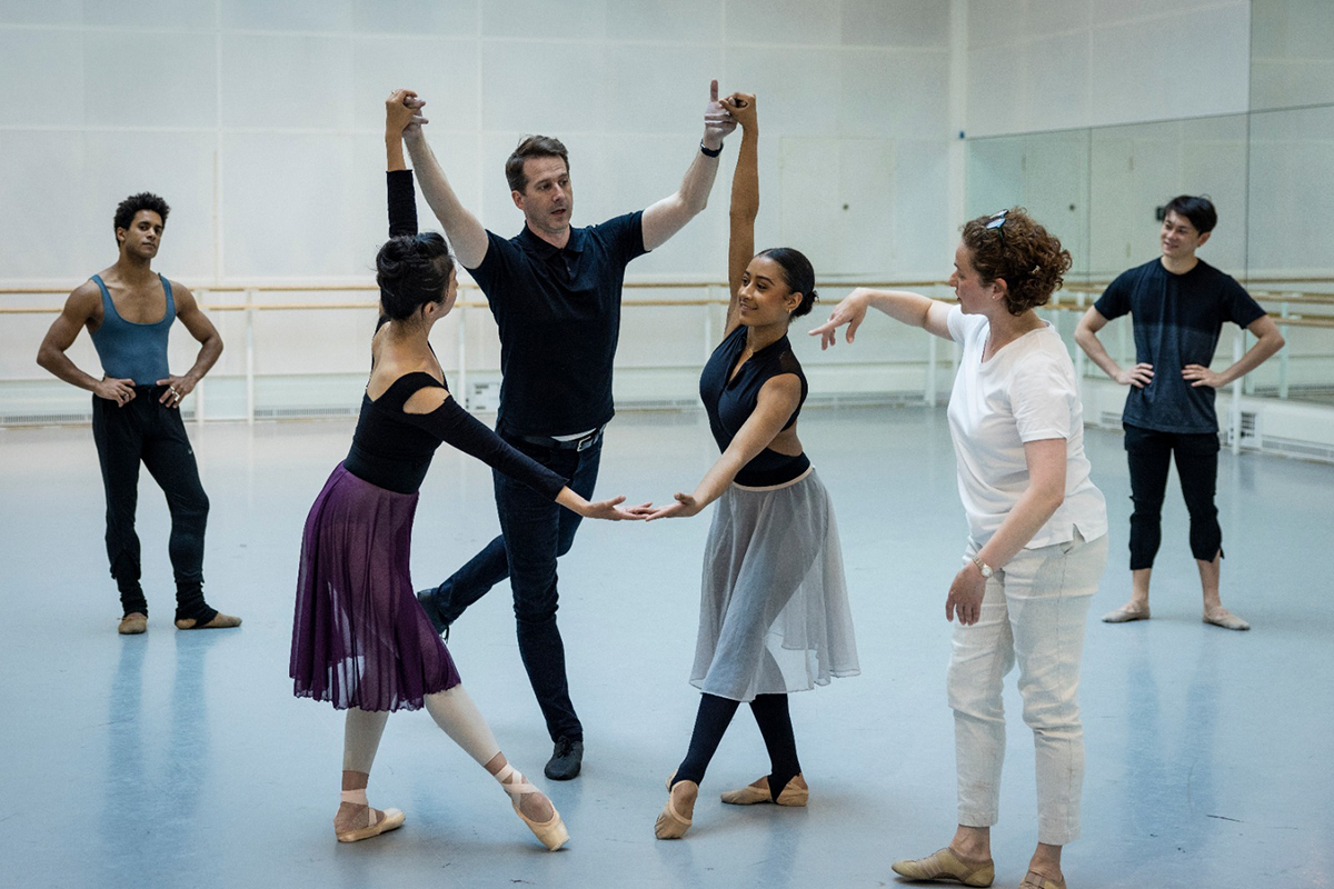 People holding hands and dancing in a studio