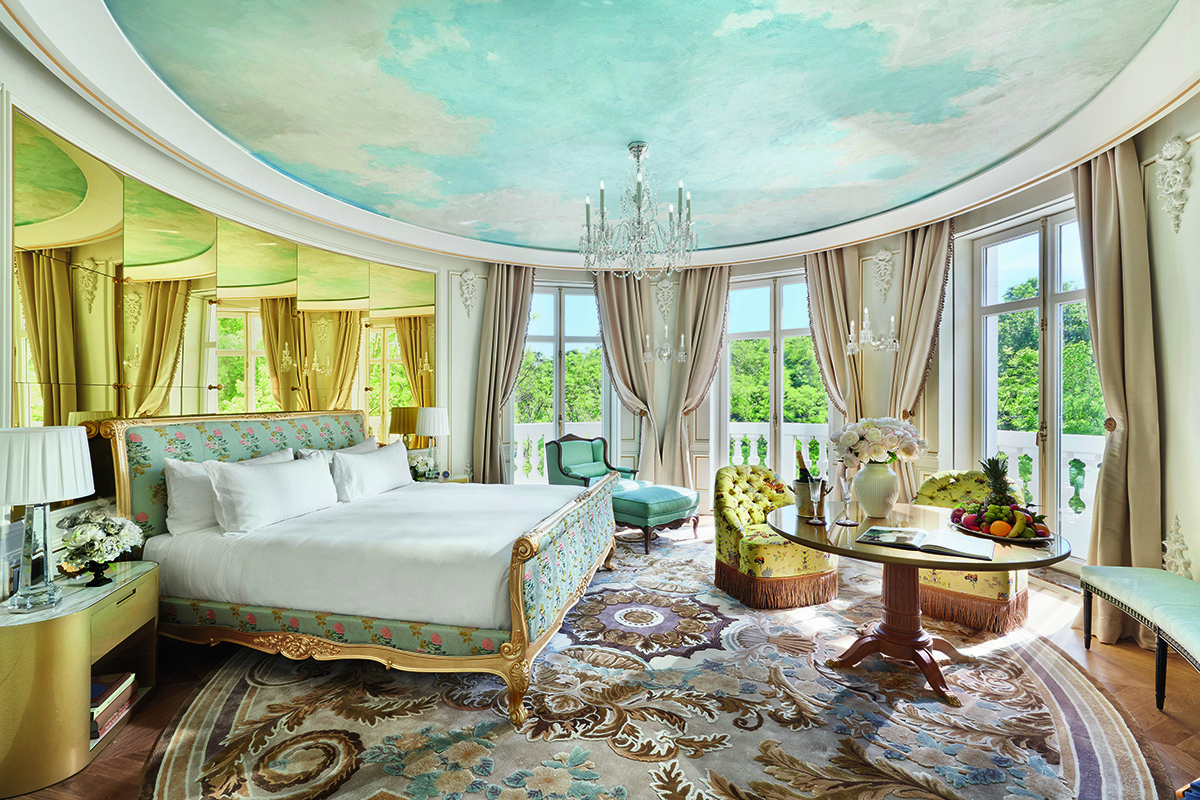 round bedroom with a sky painted on the ceiling