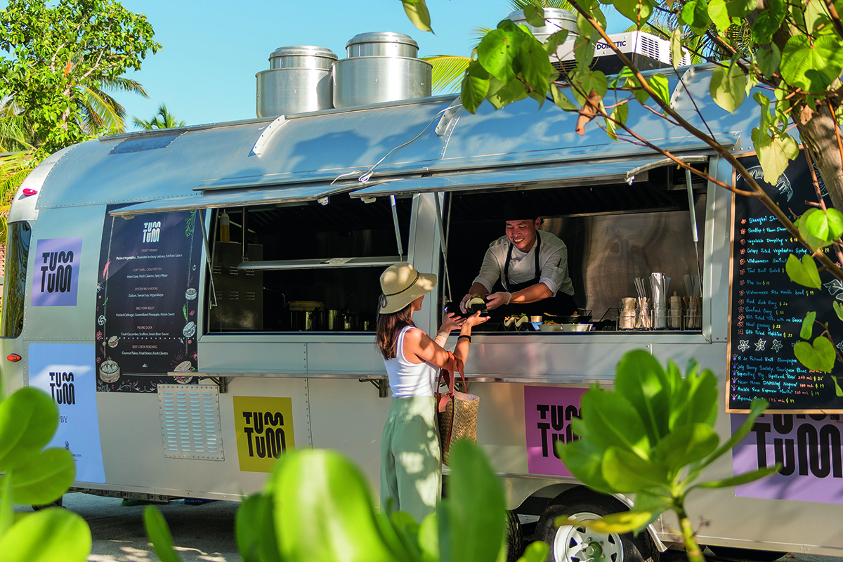 A woman standing by a food truck