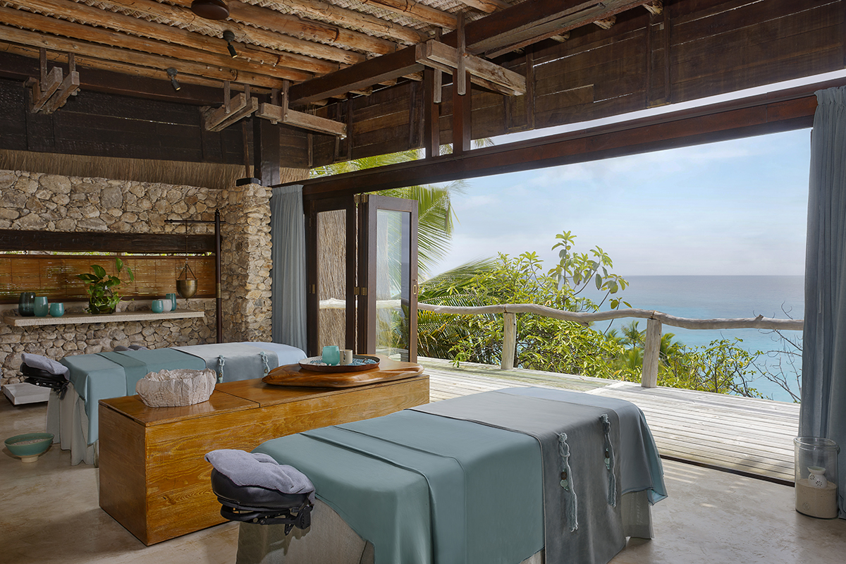 massage tables in a room overlooking the turquoise sea