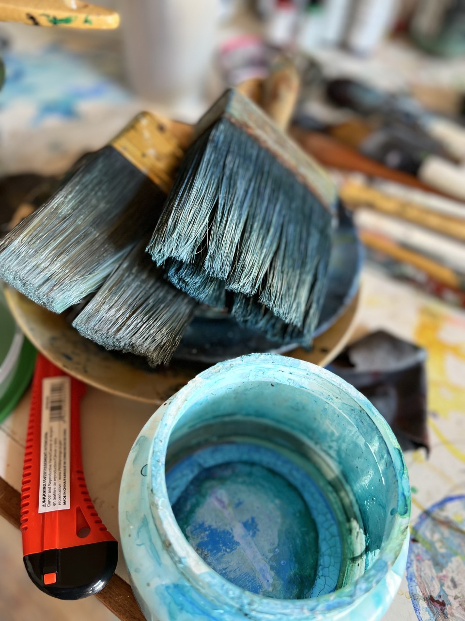 paintbrushes with blue paint on them