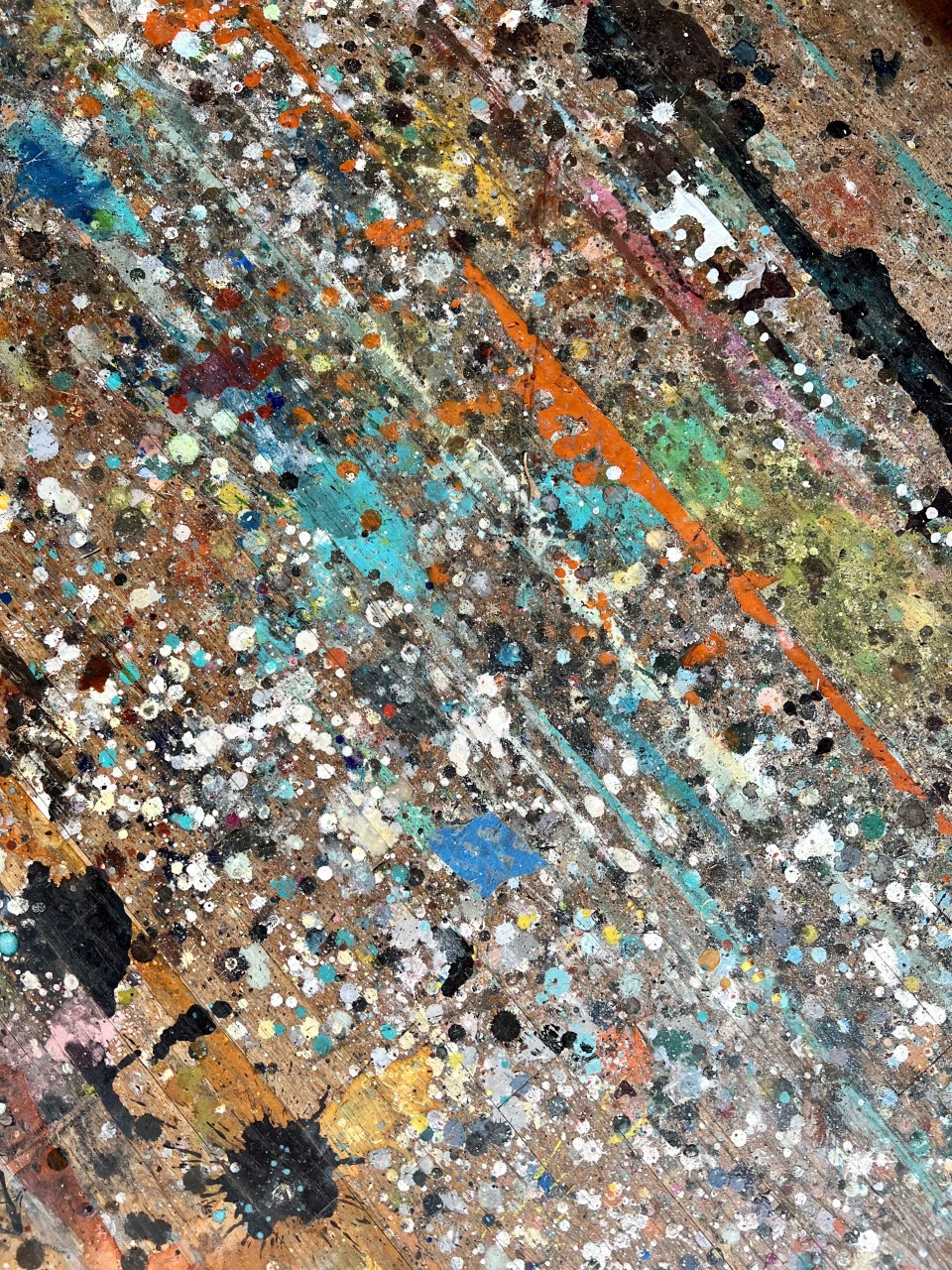 splattered multi-coloured paint on a canvas