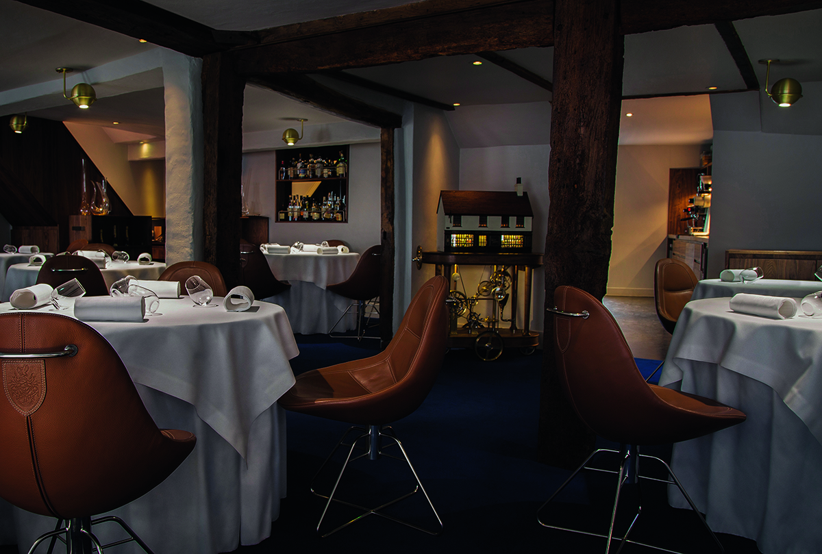 A dining room with brown leather chairs