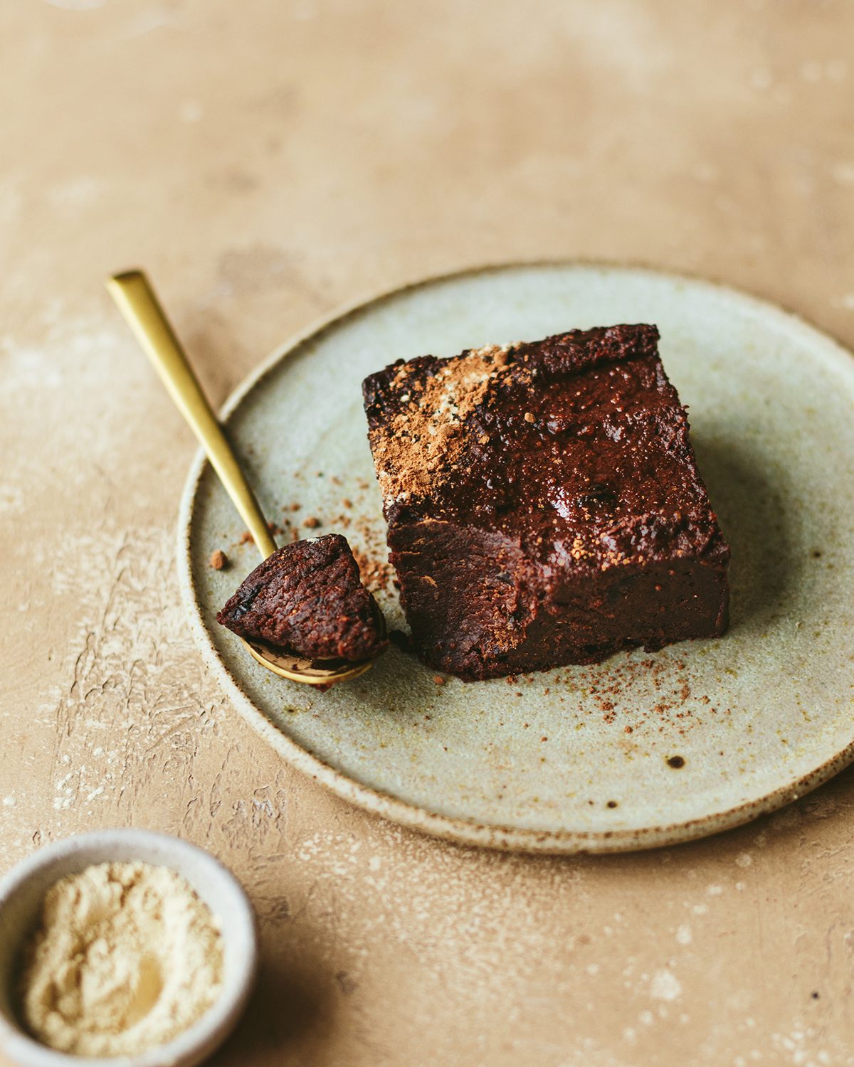 a chocolate cake with a piece on the spoon.