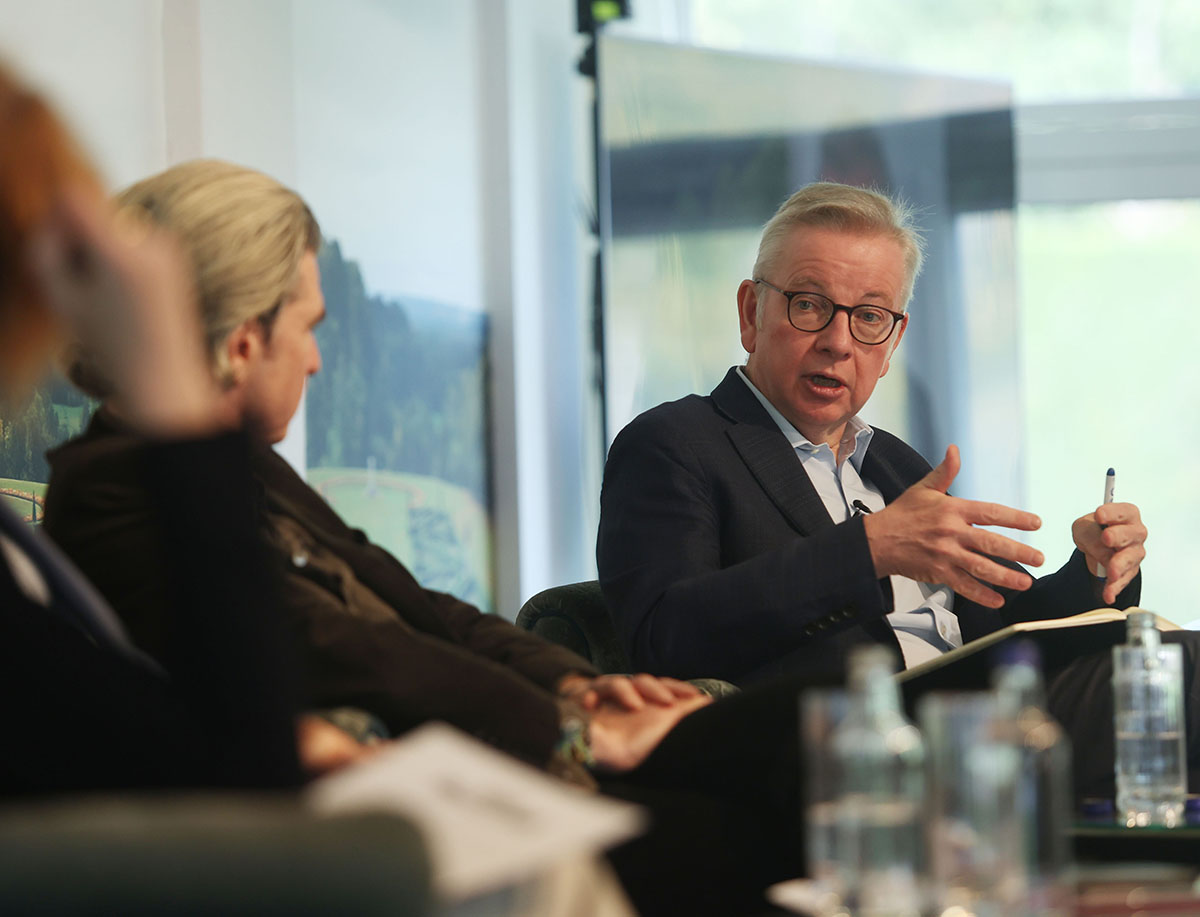 Michael Gove wearing a suit giving a talk