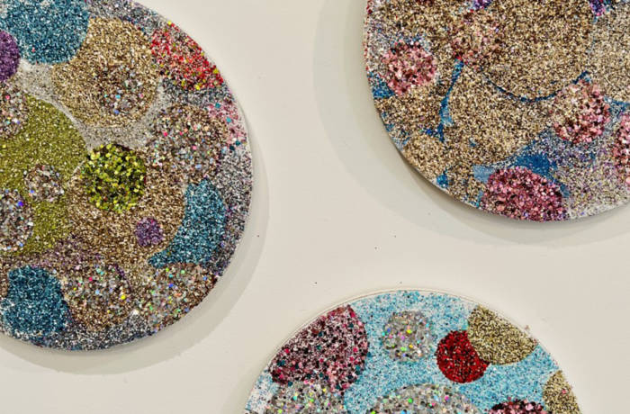 multi coloured sparkles on circle canvases