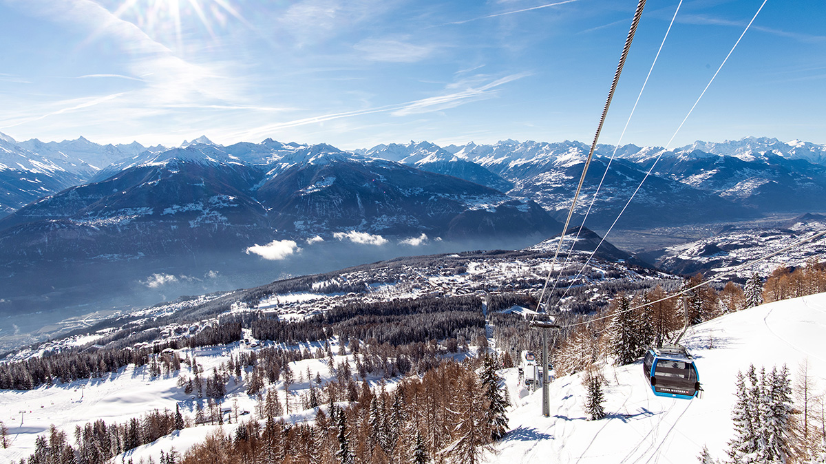 A ski village from a mountain with a cable cart