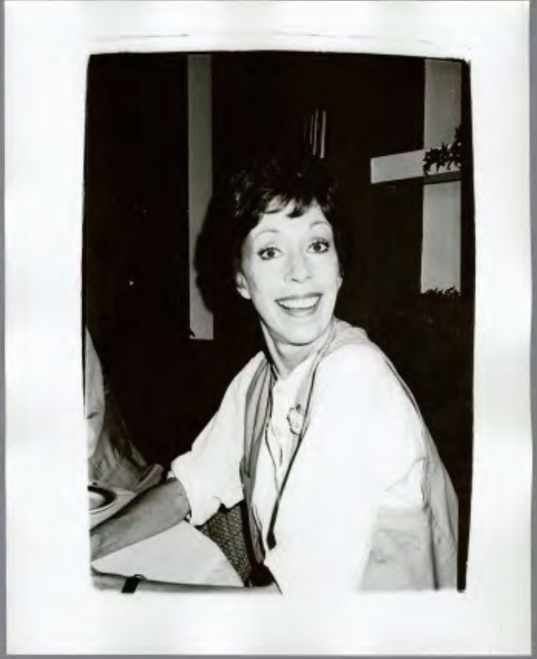 A woman with short brown hair and a fringe wearing a white blouse