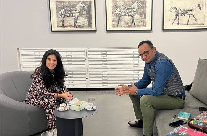 A man and woman sitting on chairs having a discussion