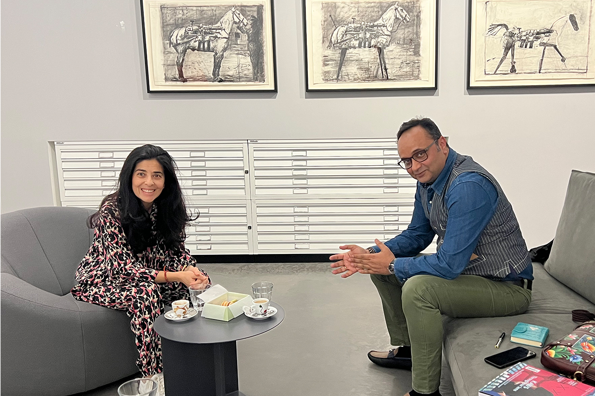 A man and woman sitting on chairs having a discussion