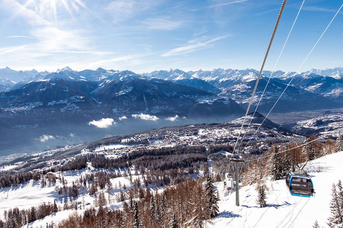 A ski village from a mountain with a cable cart