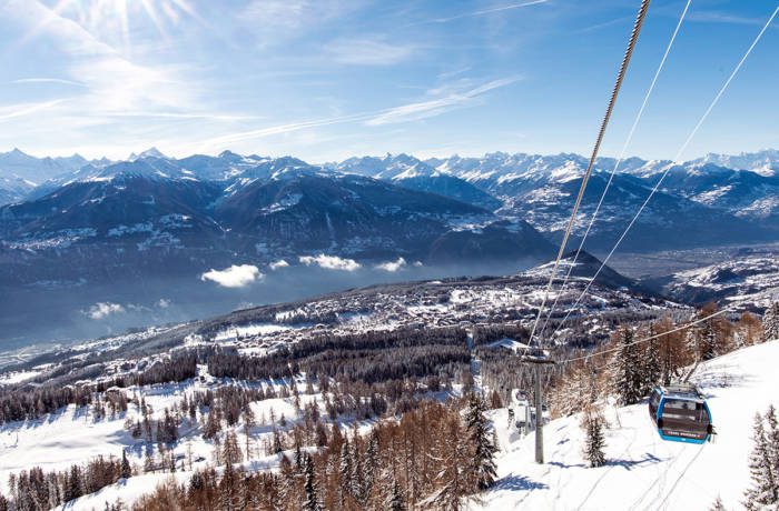 A ski village from a mountain with a cable cart