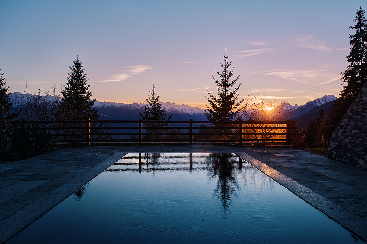 An outdoor pool with a sunset