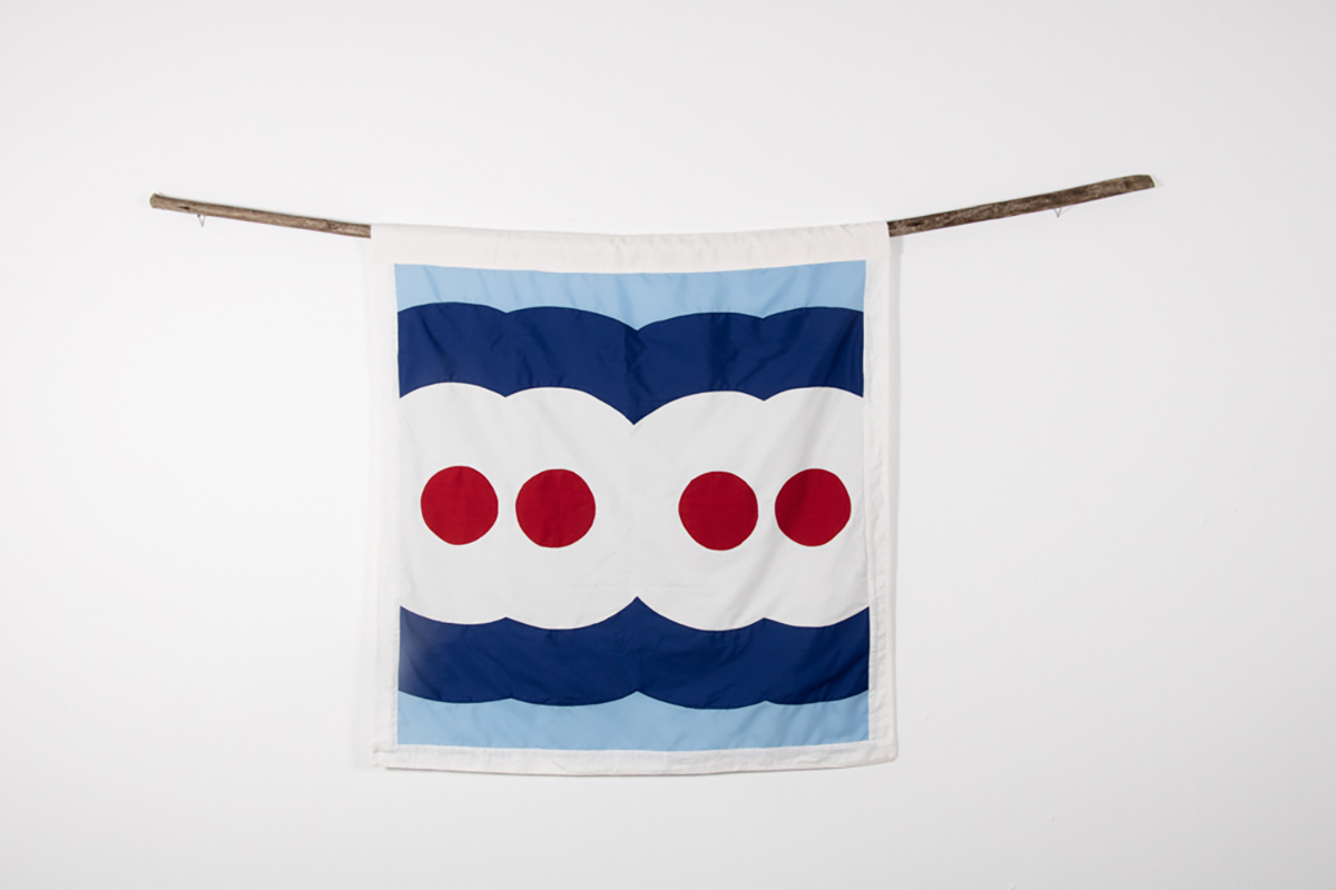 A blue red and white scarf hanging on a washing line