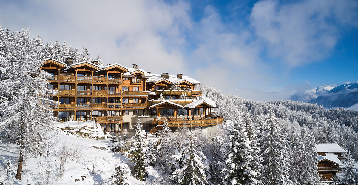 A winter chalet style hotel on the mountains covered in snow