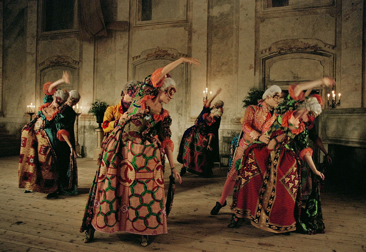 women dancing in long colourful dresses on the street