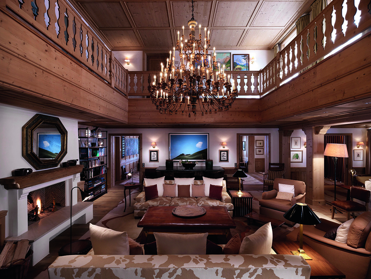 interior shot with chandelier, light brown furniture and wooden bannisters 