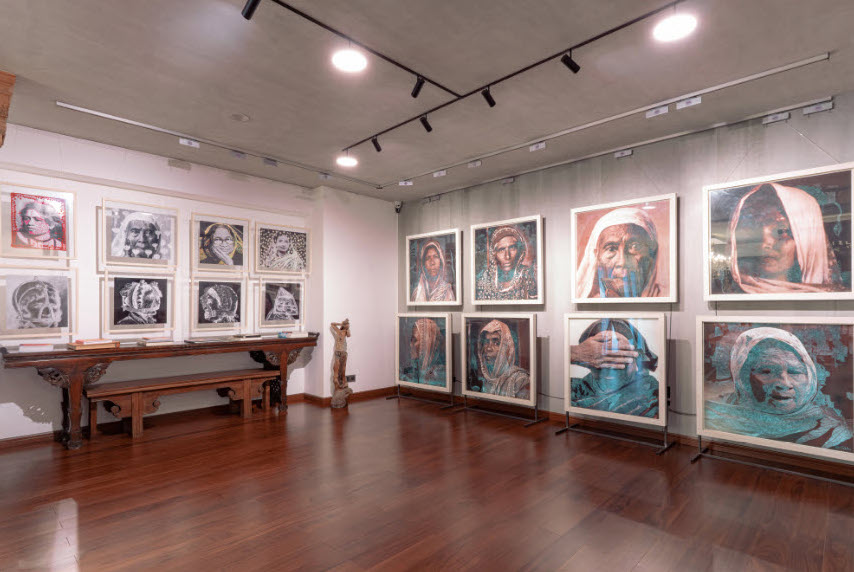 portraits in a room hung on a wall