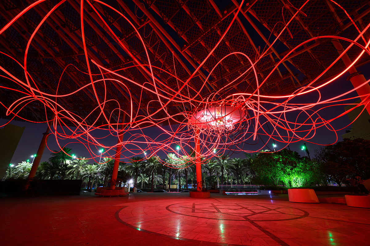 red squiggly lights in the air at night