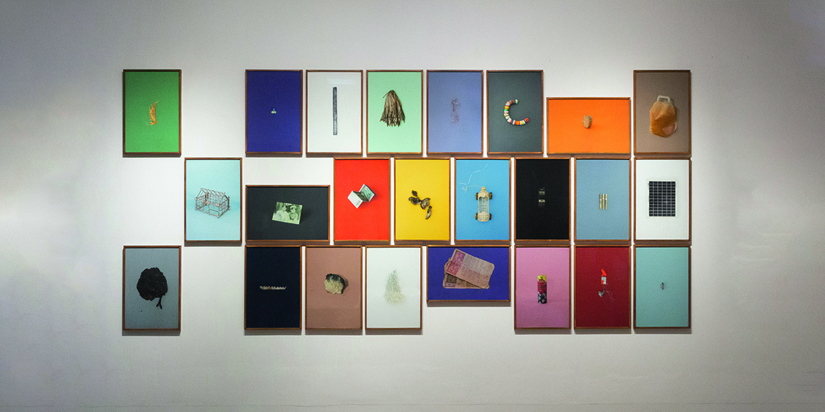 framed items on coloured canvases hung up on a wall