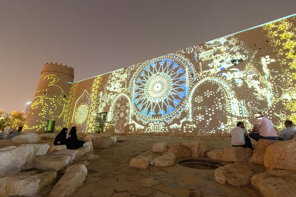 light up artwork projected on an ancient wall
