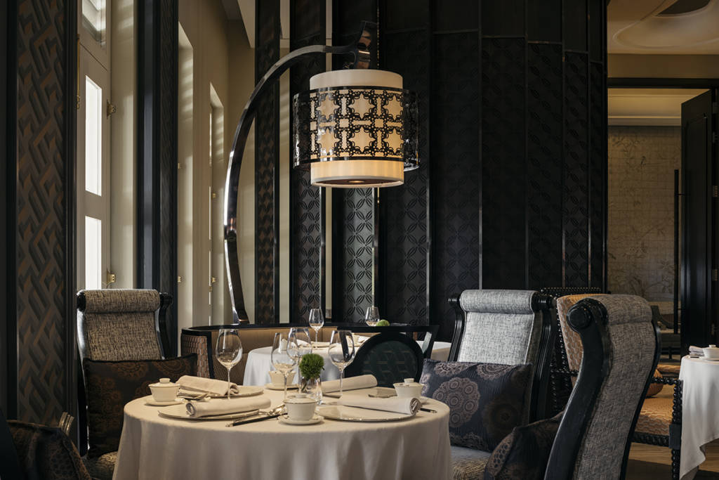 a table at a restaurant with a lantern light over the table