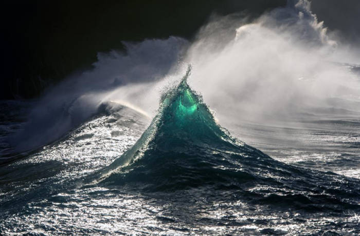 A wave in the sea with white spray