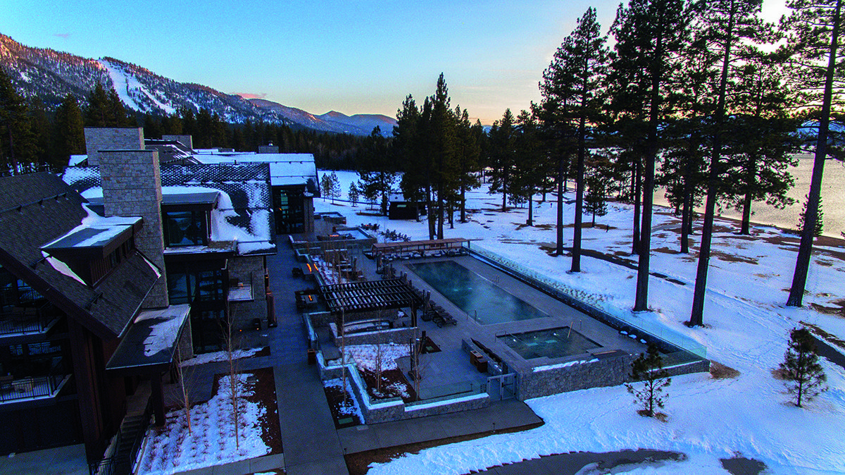 a pool surrounded by snow and trees