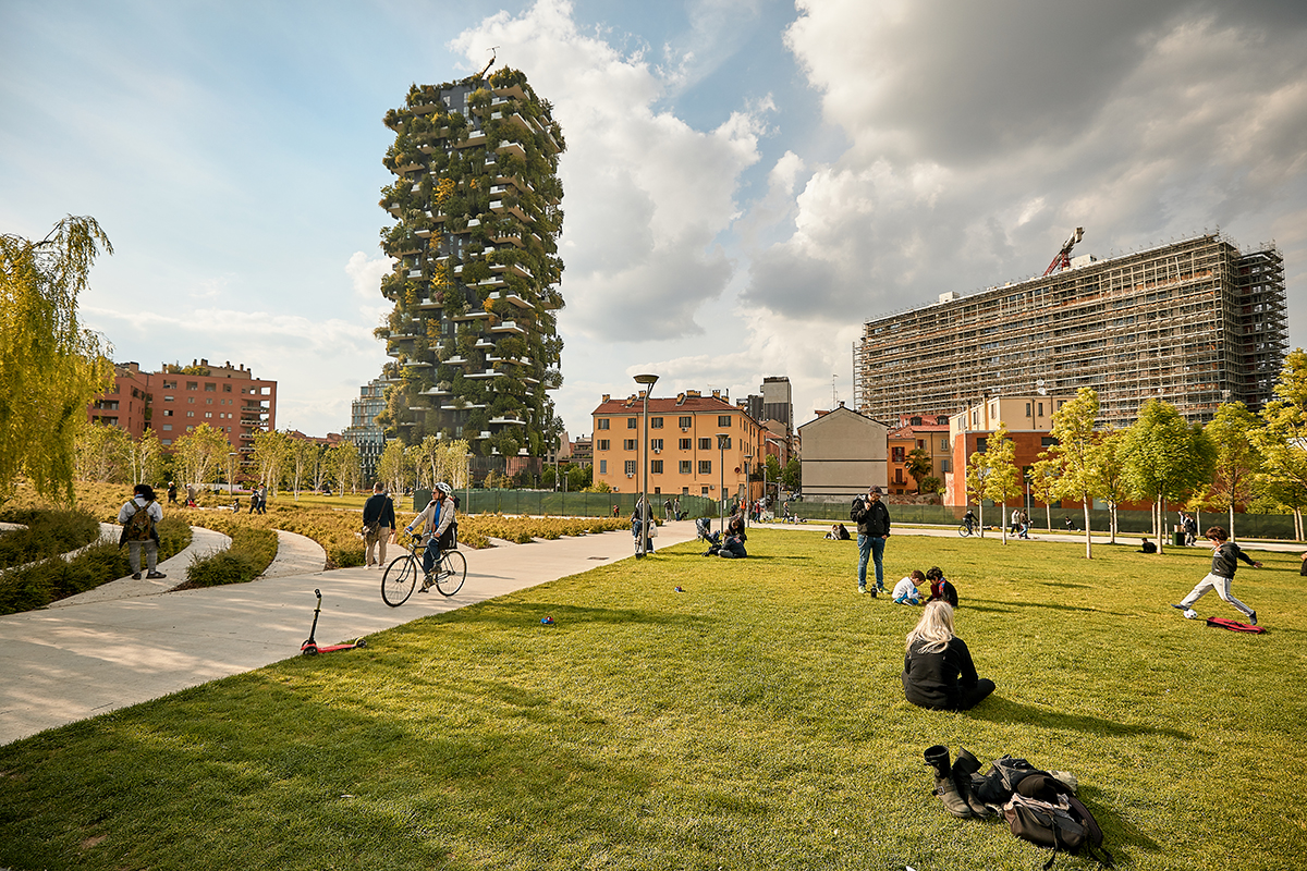 a park with a view of a building covered in plants