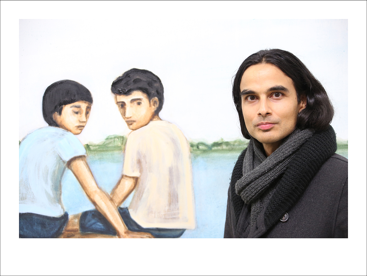A painting of two children and a real man with long black hair and a black scarf beside the painting
