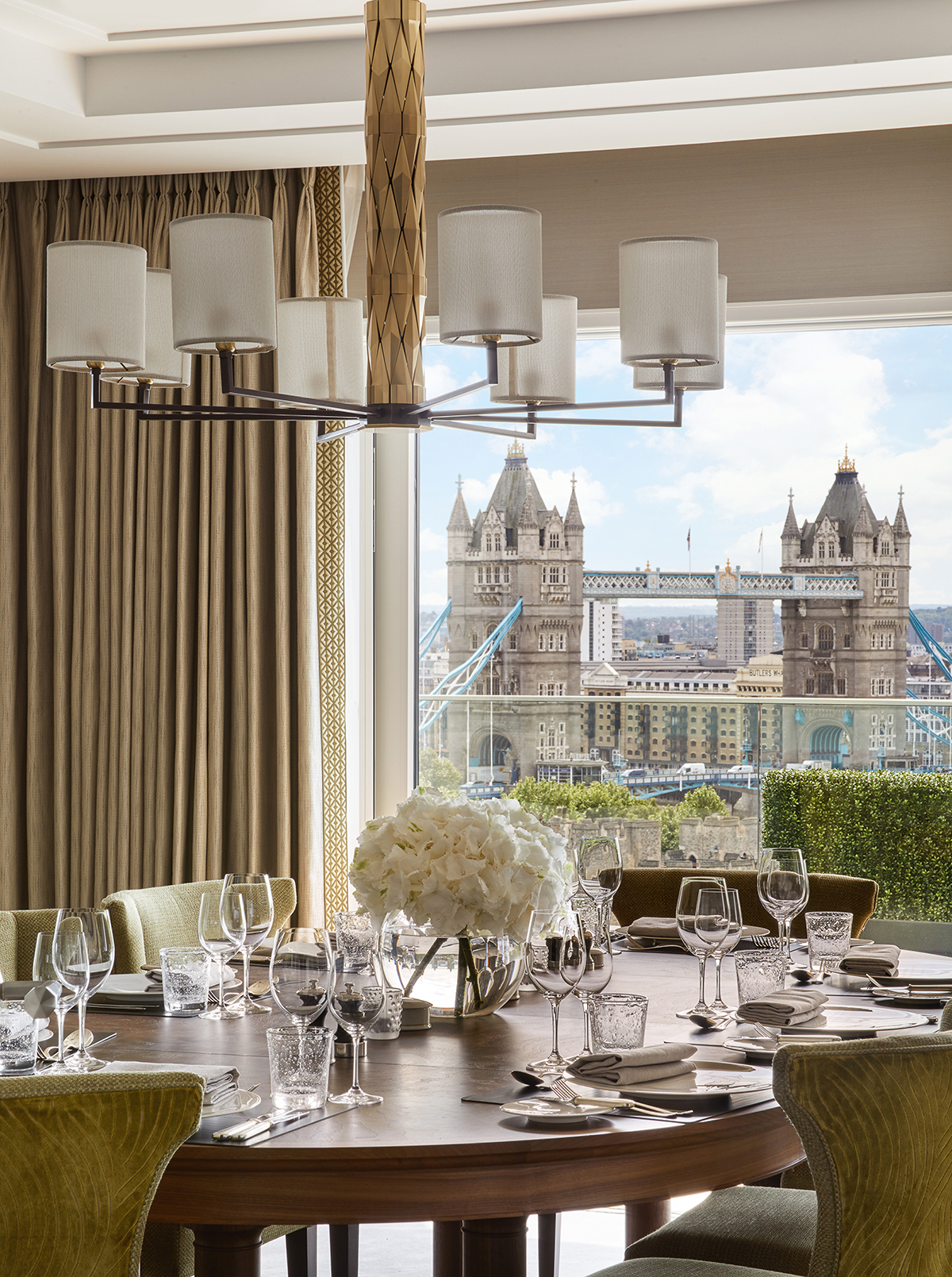 A dining room with a window view of Tower Bridge