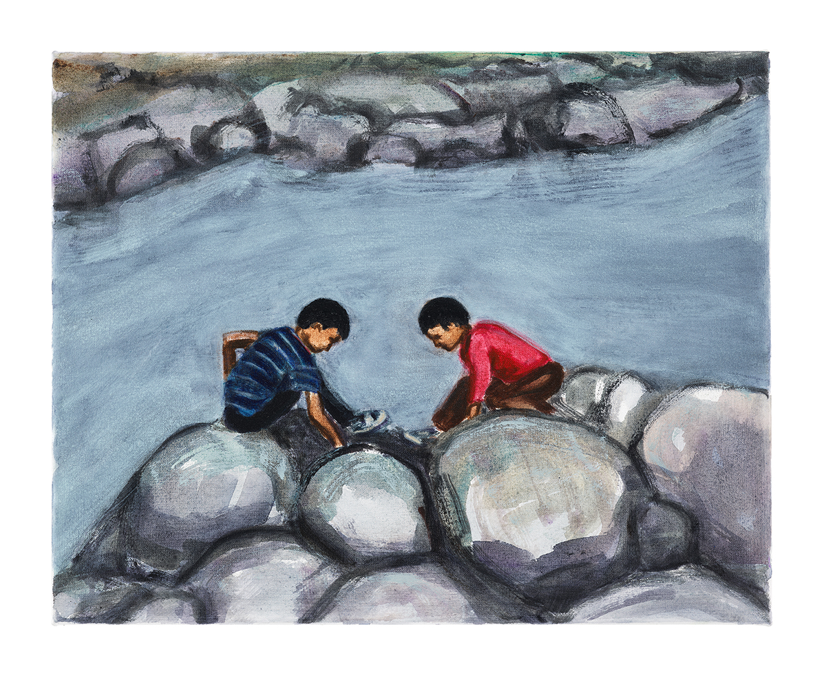 a boy in a blue top and a girl in a red top sitting on rocks playing by a stream