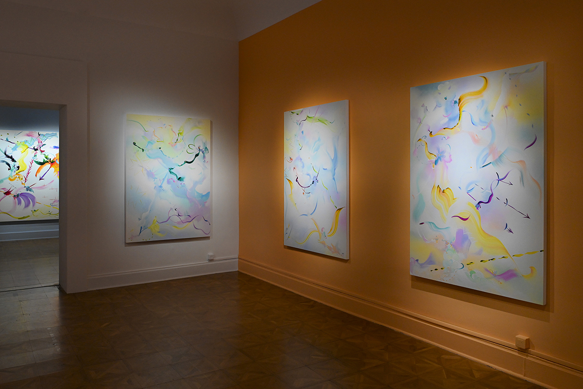 colourful blue and yellow paintings hung on a wall