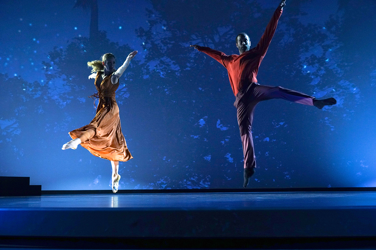 A man and woman dancing on a stage