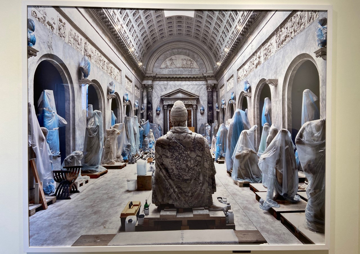 A photograph of a stone room with wrapped up statues