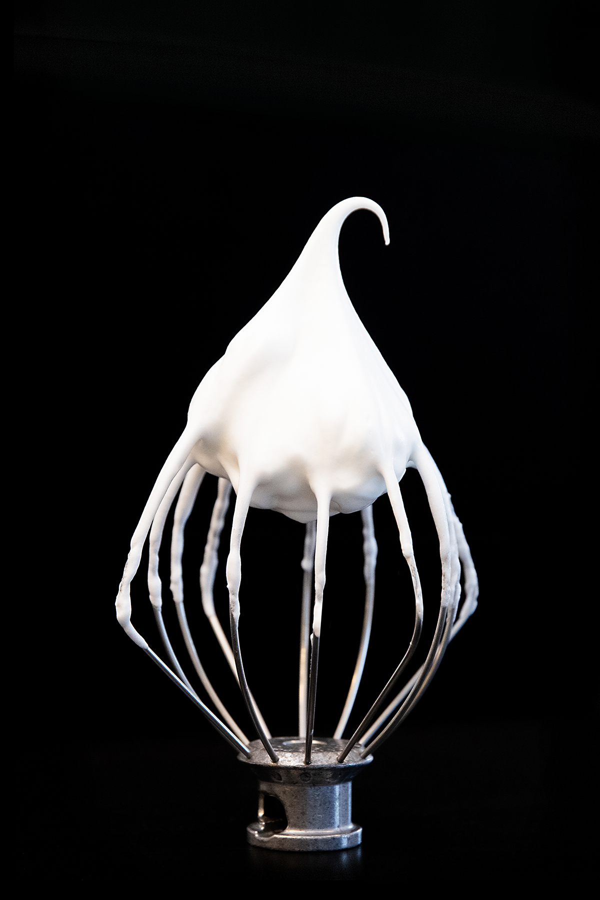 a white dripping icing on a diamond shaped object