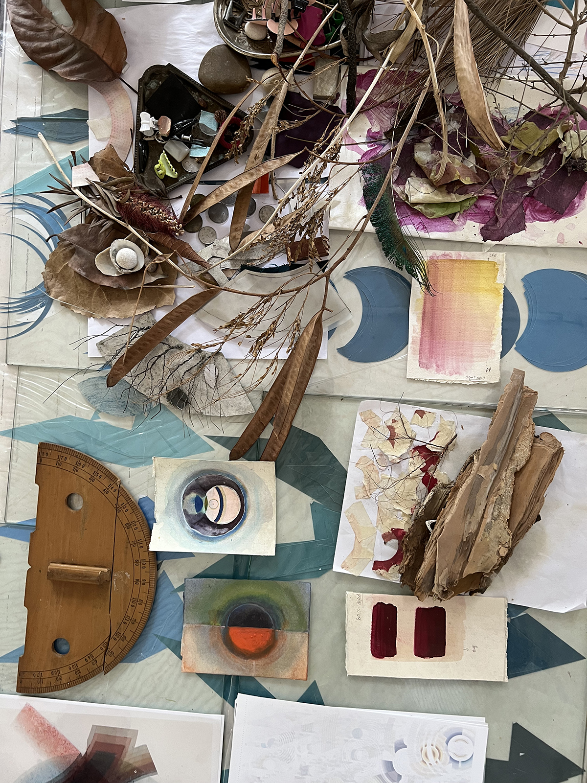 paintbrushes, paint and art on a table