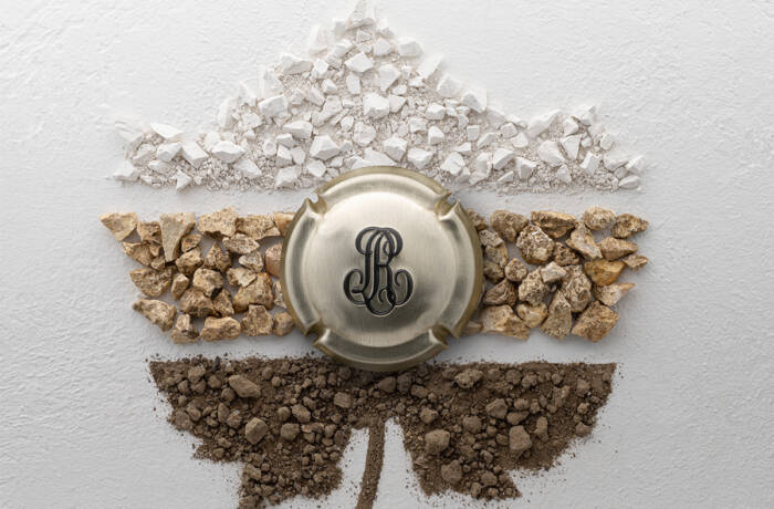 chalk and soil in the shape of a leaf with the Louis Roederer logo in the middle
