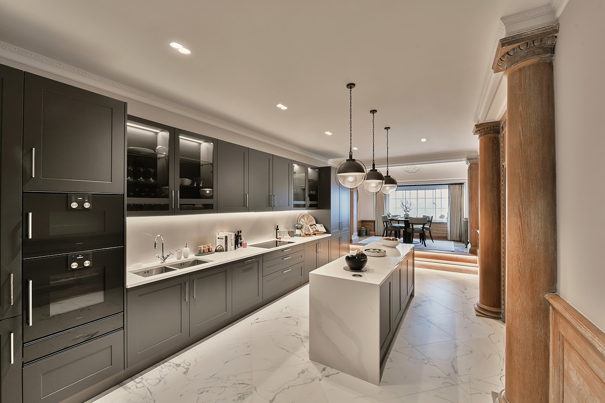 A marble and grey kitchen with an island in the middle